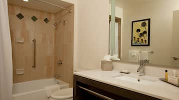 A bathroom with a bathtub, toilet, and sink.