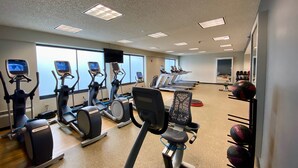 A gym with multiple treadmills, elliptical machines, and a weight rack. - Doubletree by Hilton Somerset Hotel and Conference Center (Somerset)