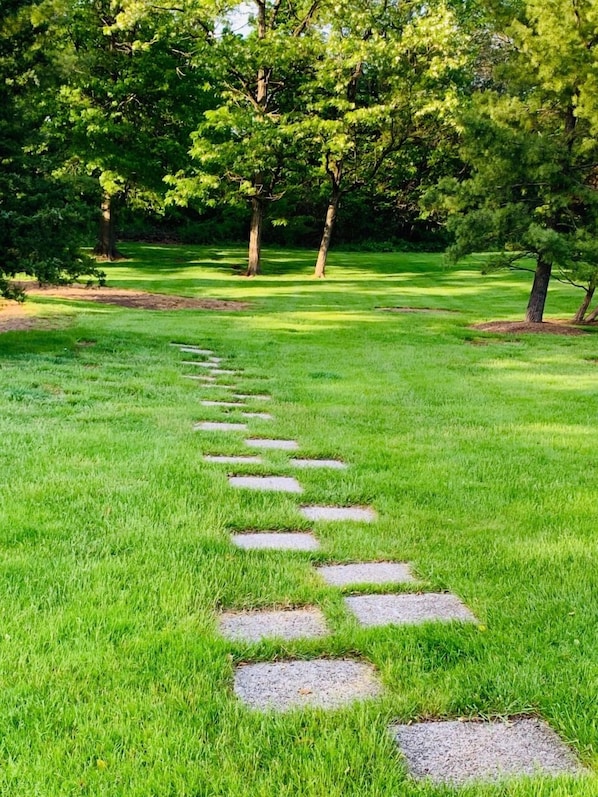 A pathway with stepping stones in a grassy area surrounded by trees. - Doubletree by Hilton Somerset Hotel and Conference Center (Somerset)
