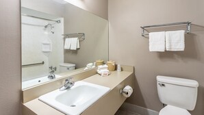 A hotel bathroom with a sink, mirror, toilet, and towel rack. - Red Roof Inn Meridian (Meridian)