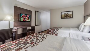 A hotel room with two beds, a TV, a desk, and a mirror. - Red Roof Inn Meridian (Meridian)