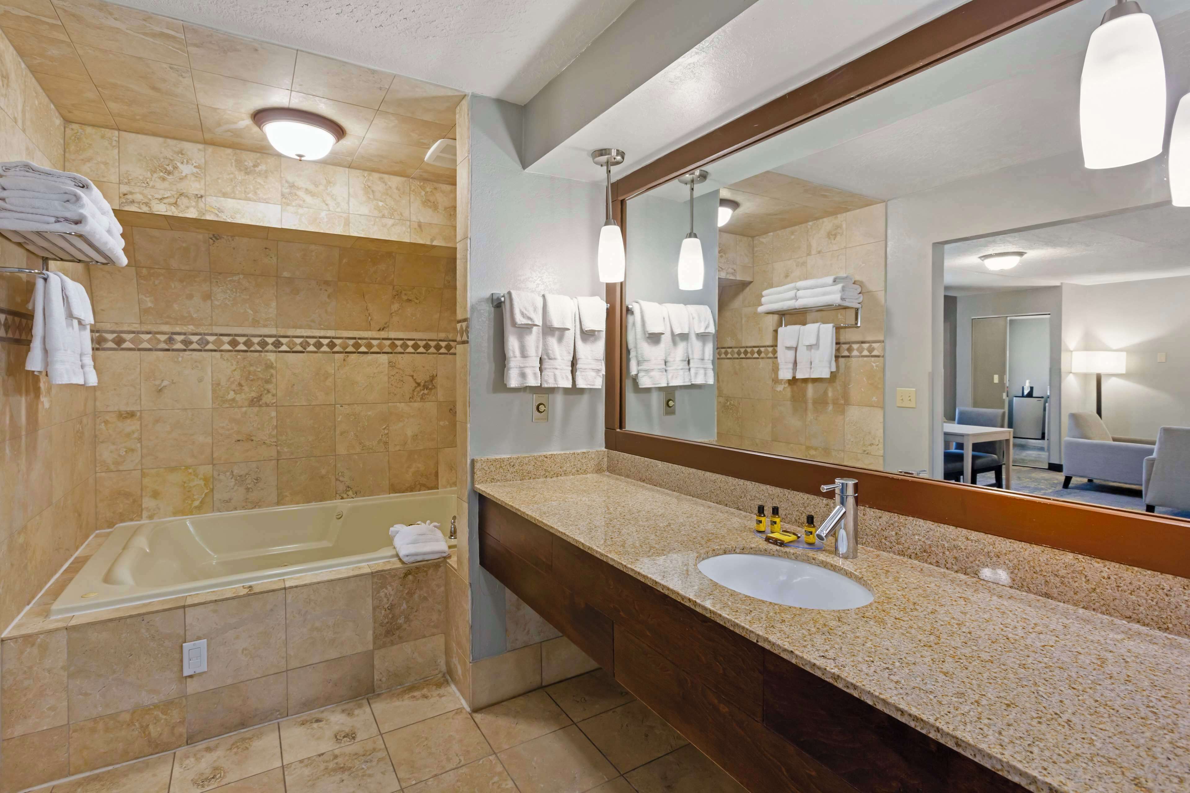 junior suite, 1 king bed, non smoking, jetted tub | bathroom | combined shower/bathtub, free toiletries, hair dryer, towels