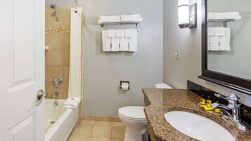 A bathroom with a bathtub, toilet, sink, and towel rack.