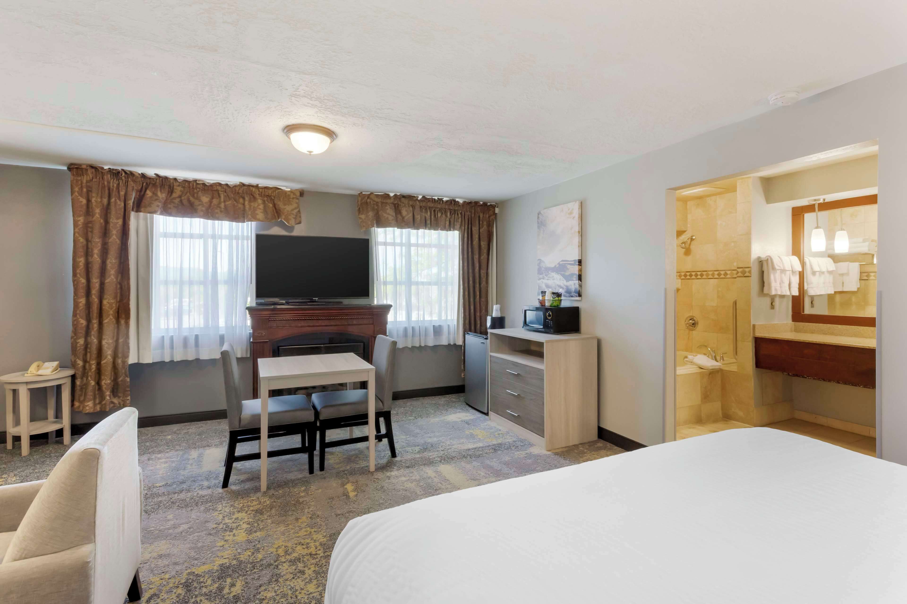 junior suite, 1 king bed, non smoking, jetted tub | desk, laptop workspace, blackout curtains, iron/ironing board