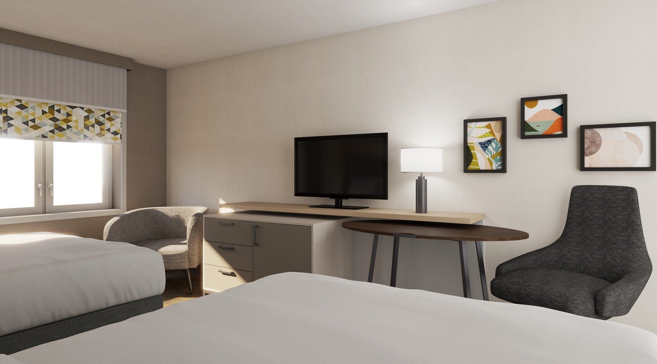 A hotel room with a bed, a desk with a TV, a chair, and artwork on the wall.