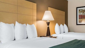 A hotel room with two beds, a lamp, and a painting on the wall. - Quality Inn Geneseo (Geneseo)