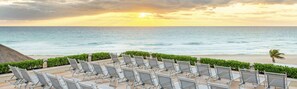 On the beach, white sand, beach cabanas, sun loungers
