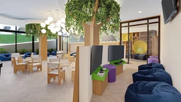 A modern indoor space with wooden furniture, a large tree with green foliage, and a flat-screen TV.
