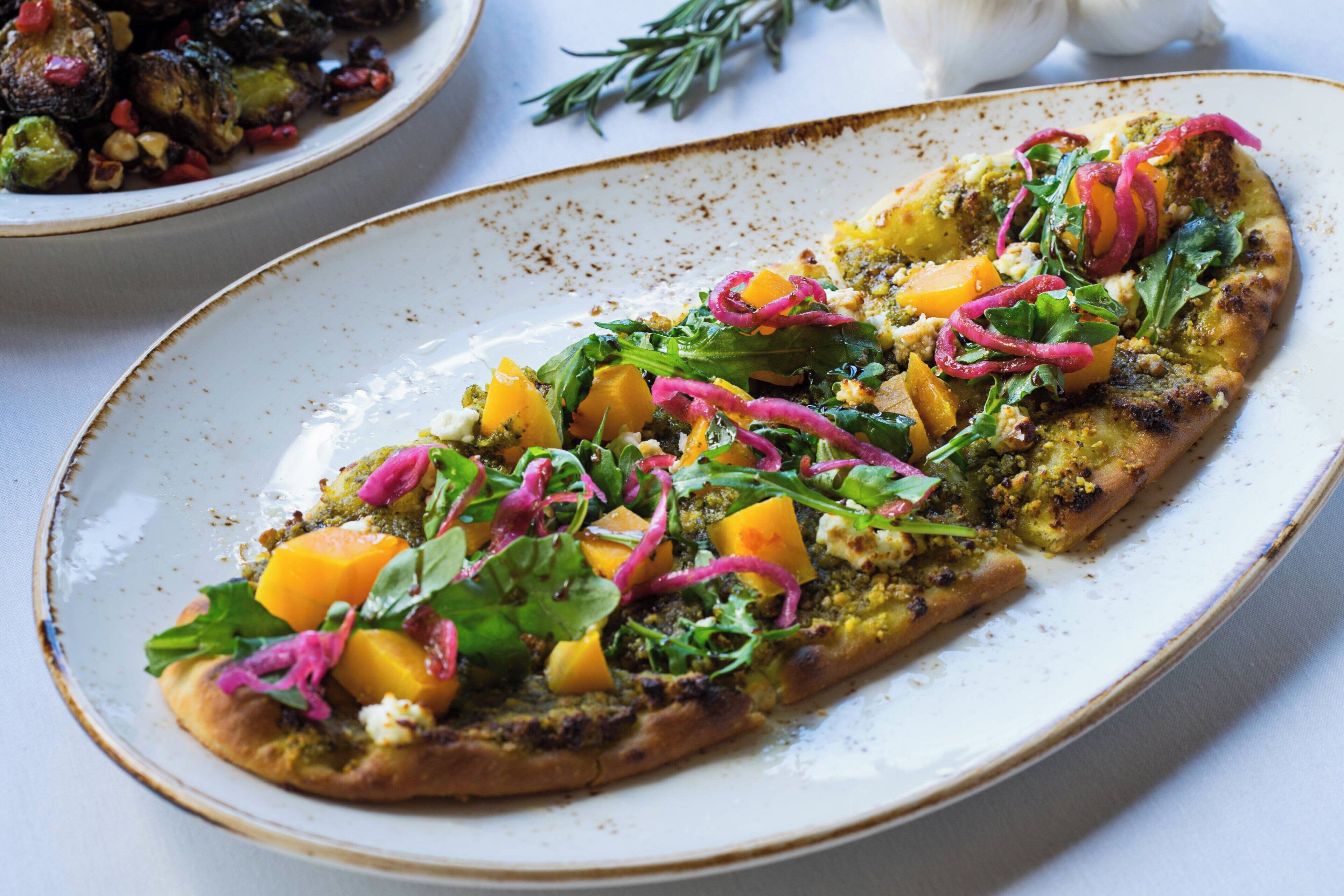 A pizza with various toppings on a plate.