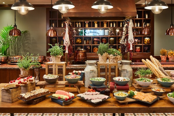 A buffet table with various food items and a selection of books.