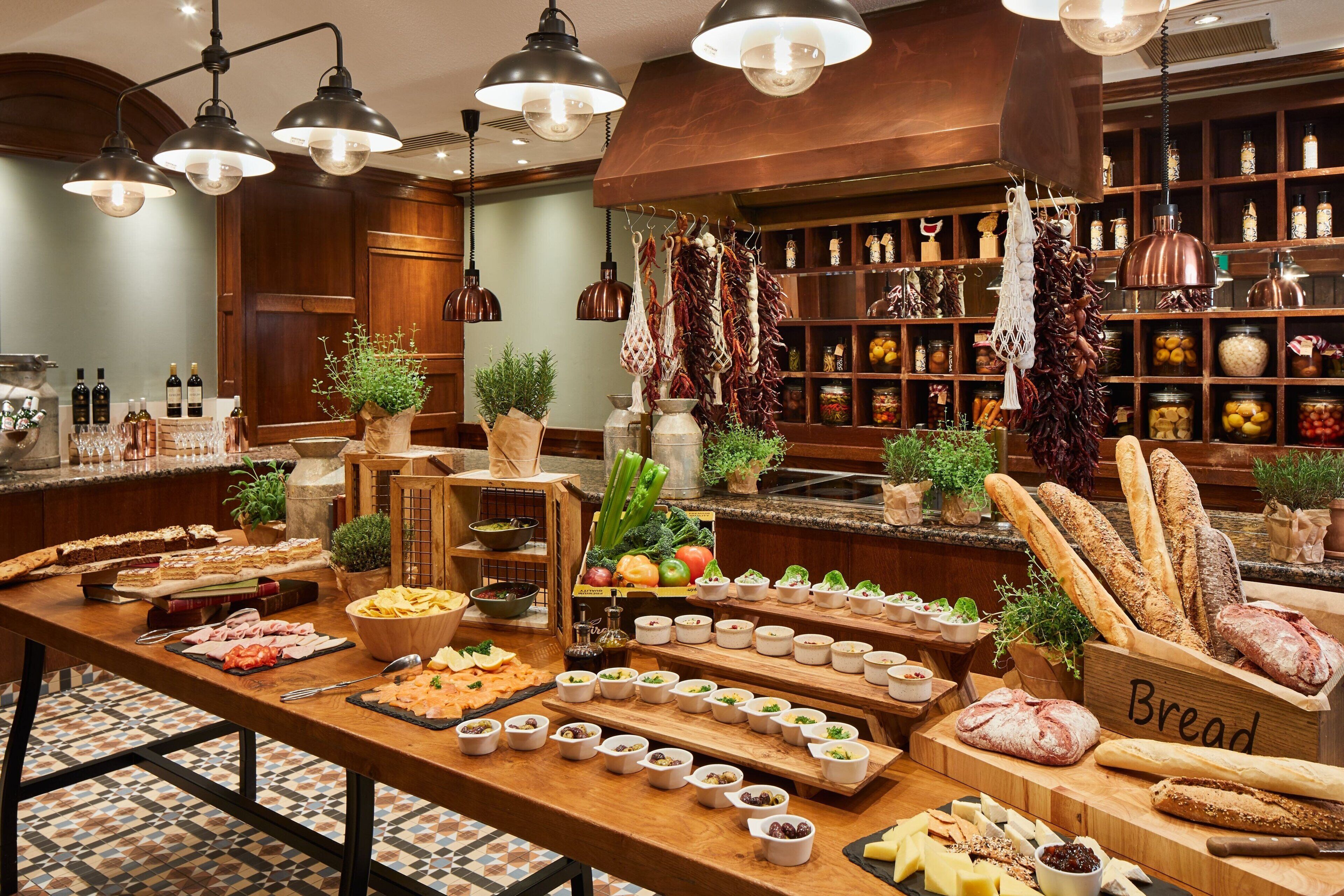 A buffet with various food items, including bread, cheese, and vegetables.