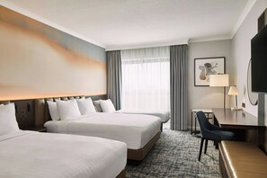 A hotel room with two beds, a desk, a chair, a television, and a large window with curtains. - London Marriott Hotel Marble Arch (London)