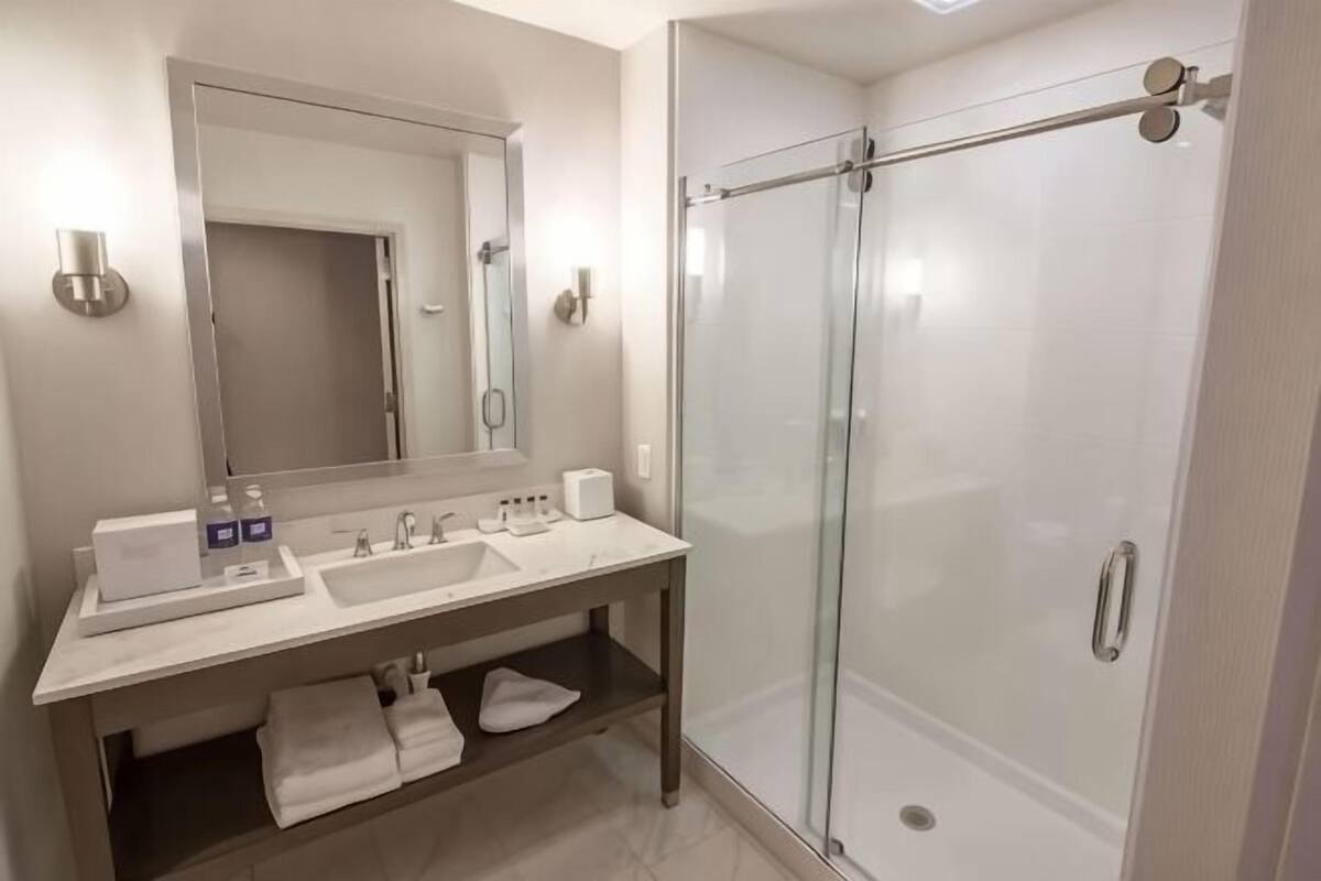 Shower, designer toiletries, hair dryer, bathrobes