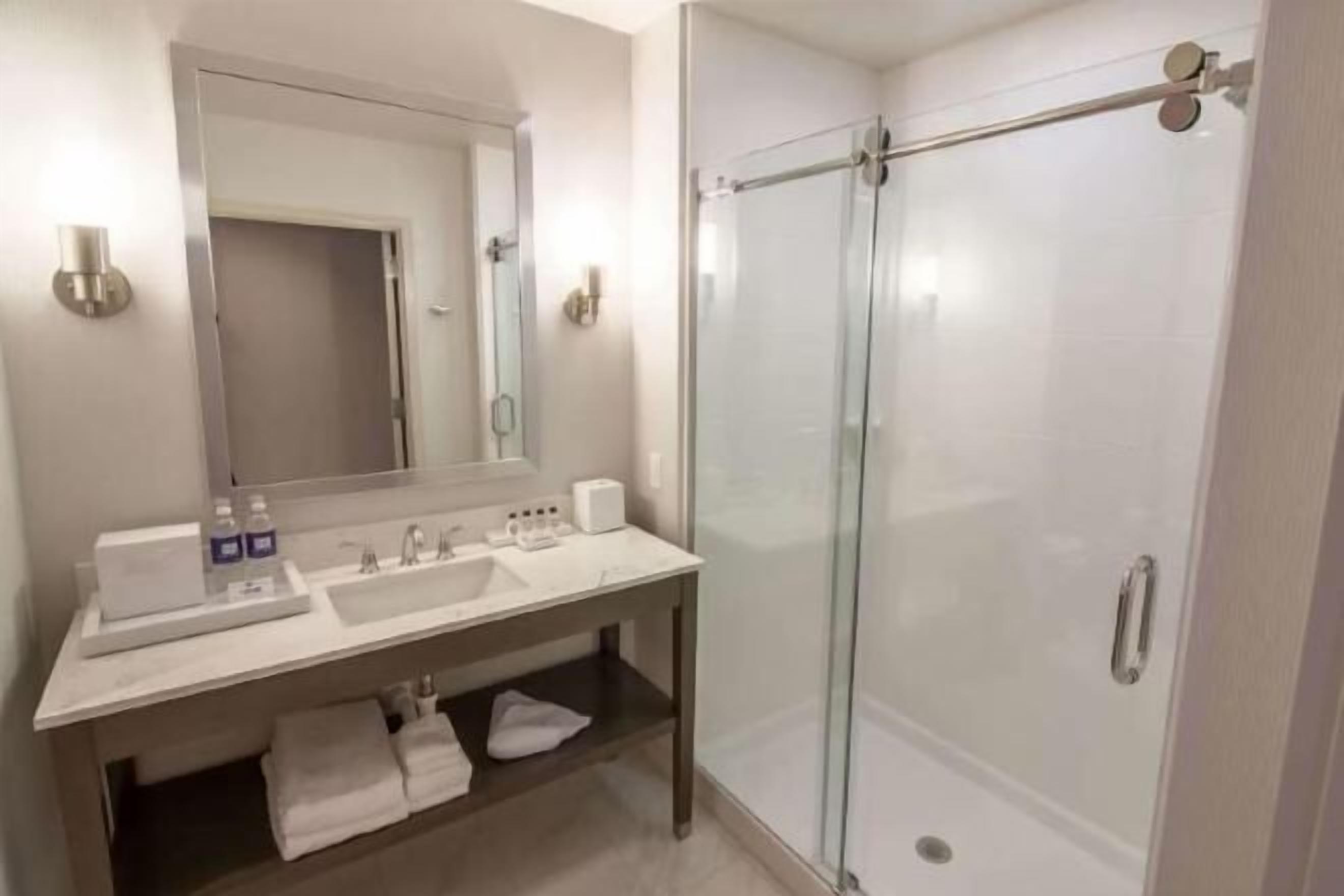 Shower, designer toiletries, hair dryer, bathrobes