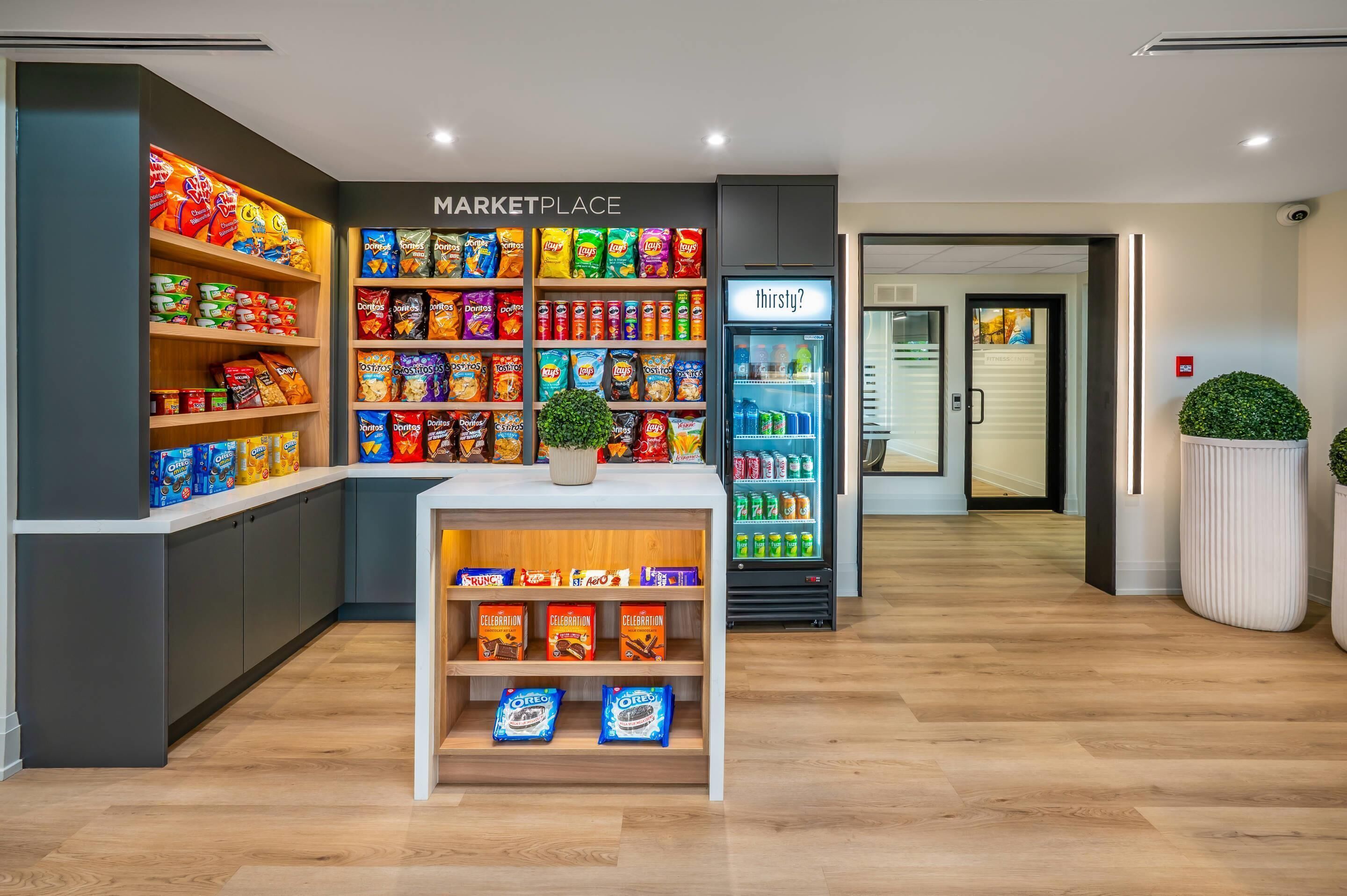 A modern marketplace with shelves of snacks and a refrigerated section.