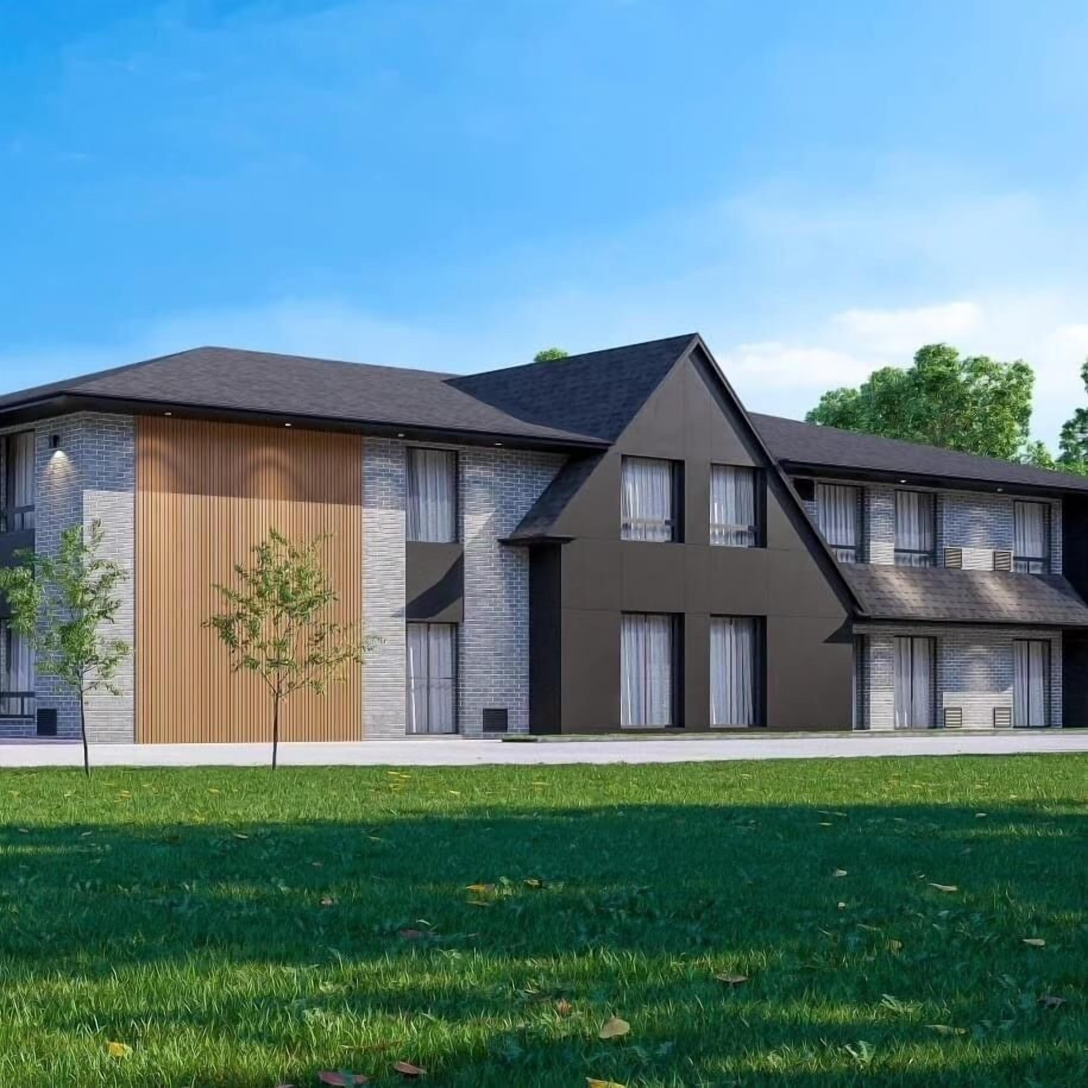 Un edificio moderno a due piani con tetto piatto, ampie finestre e un rivestimento in mattoni e legno.