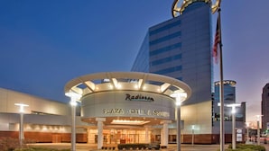 The Radisson Plaza Hotel & Suites with a modern design, featuring a circular entrance canopy and a tall building with a circular top. - Radisson Plaza Hotel at Kalamazoo Center (Kalamazoo)