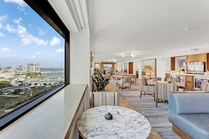 A modern hotel lobby with a city view, a bar area, and seating arrangements. - InterContinental Miami by IHG (Miami)