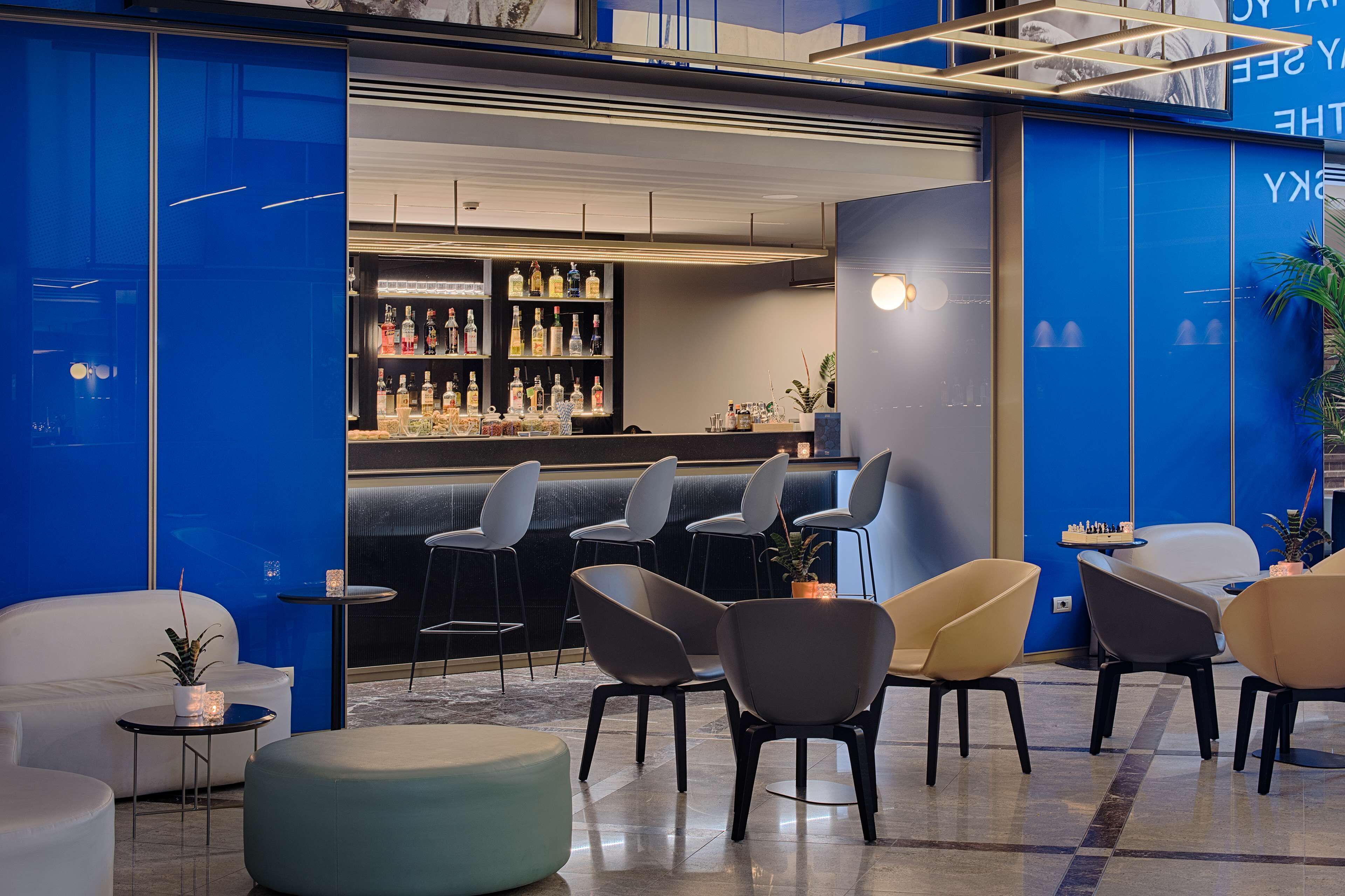 A modern lounge area with seating and a bar.