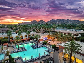 A resort with a swimming pool, lounge areas, and a view of the surrounding landscape. - Omni Scottsdale Resort & Spa at Montelucia (Paradise Valley)