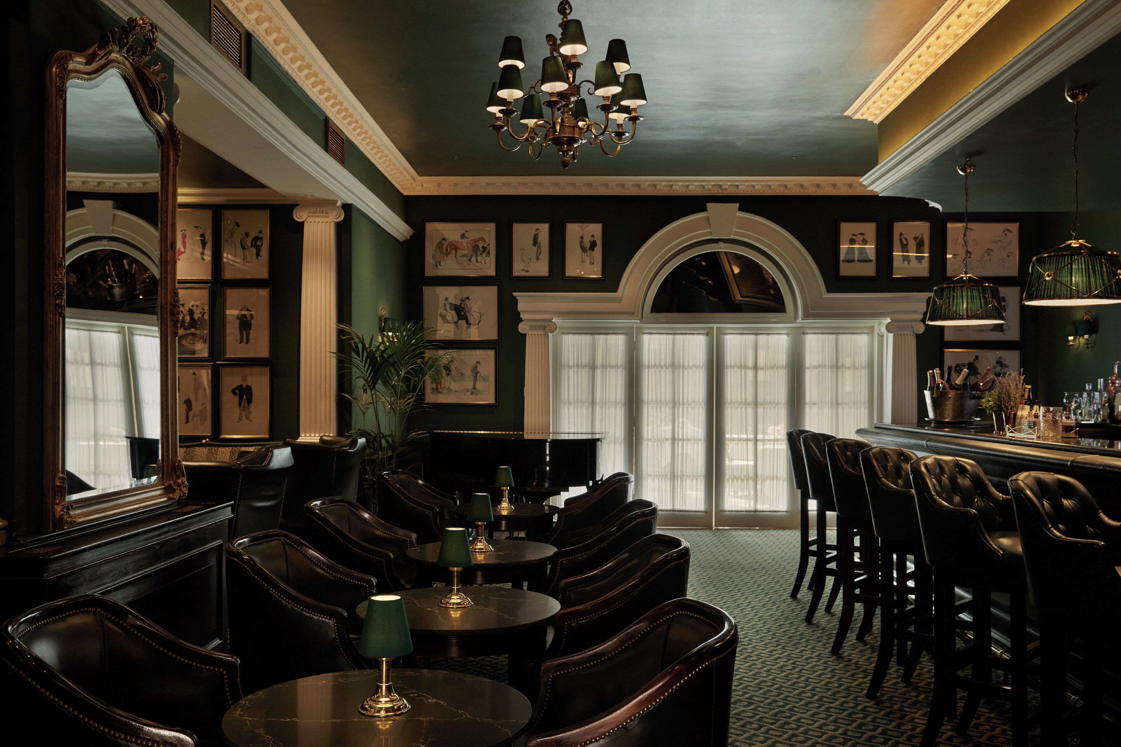 A formal dining area with dark wood furniture, a chandelier, and framed artwork on the walls.