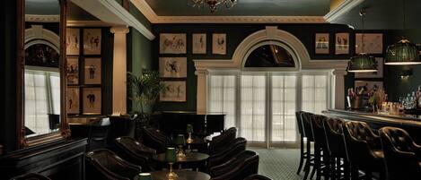 A formal dining area with dark wood furniture, a chandelier, and framed artwork on the walls.