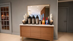 A modern bathroom with a wooden vanity, a large mirror, and various toiletries.