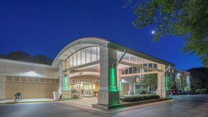 A modern building with a curved entrance and a covered walkway.