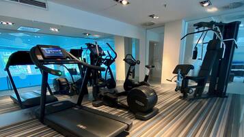 A modern gym with treadmills, an elliptical, and a stationary bike.