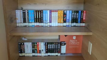 A wooden bookshelf with multiple shelves filled with books.