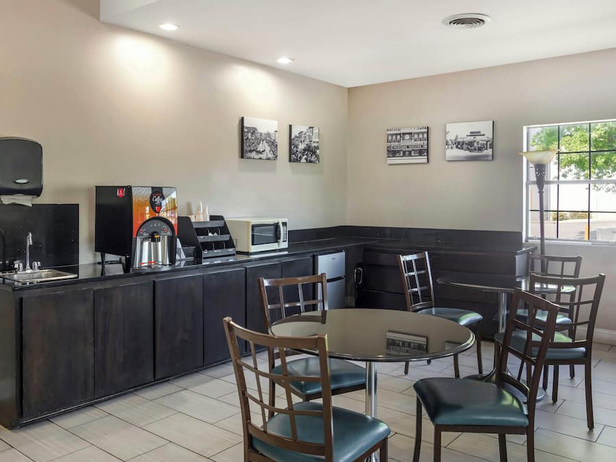 A restaurant with a bar area, seating, and wall art.