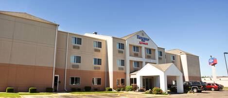 A multi-story hotel with a prominent sign for Fairfield Inn by Marriott.