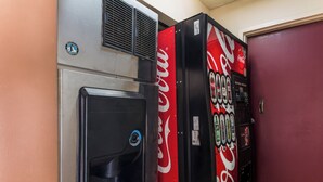 A vending machine with a Coca-Cola logo and a water dispenser with a logo. - Red Roof Inn Texarkana (Texarkana)