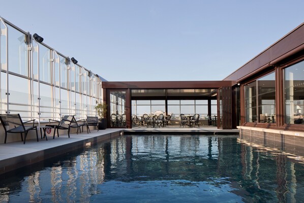 Indoor pool, seasonal outdoor pool, open 10 AM to 8 PM, pool loungers