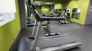 A gym with treadmills, exercise bikes, and weight machines.