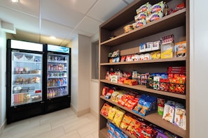 A snack and beverage section with refrigerated drinks and a variety of snacks. - Holiday Inn Express San Francisco Airport South by IHG (Burlingame)