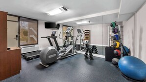A fitness room with a treadmill, elliptical, and free weights. - Days Inn by Wyndham Raleigh Midtown (Raleigh)