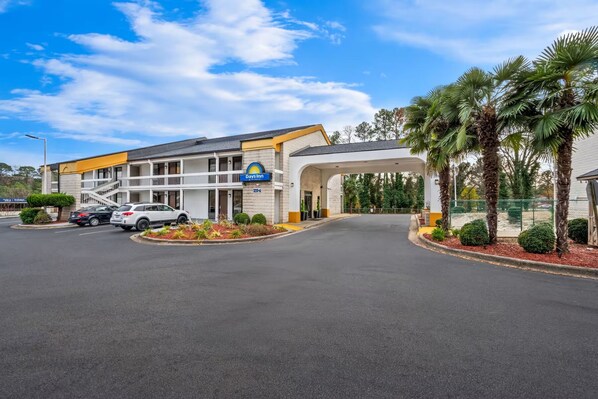A Days Inn with a covered parking area, a two-story building, and a landscaped entrance.