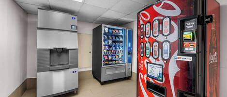 A vending machine area with a Coca-Cola branded machine and a water dispenser.