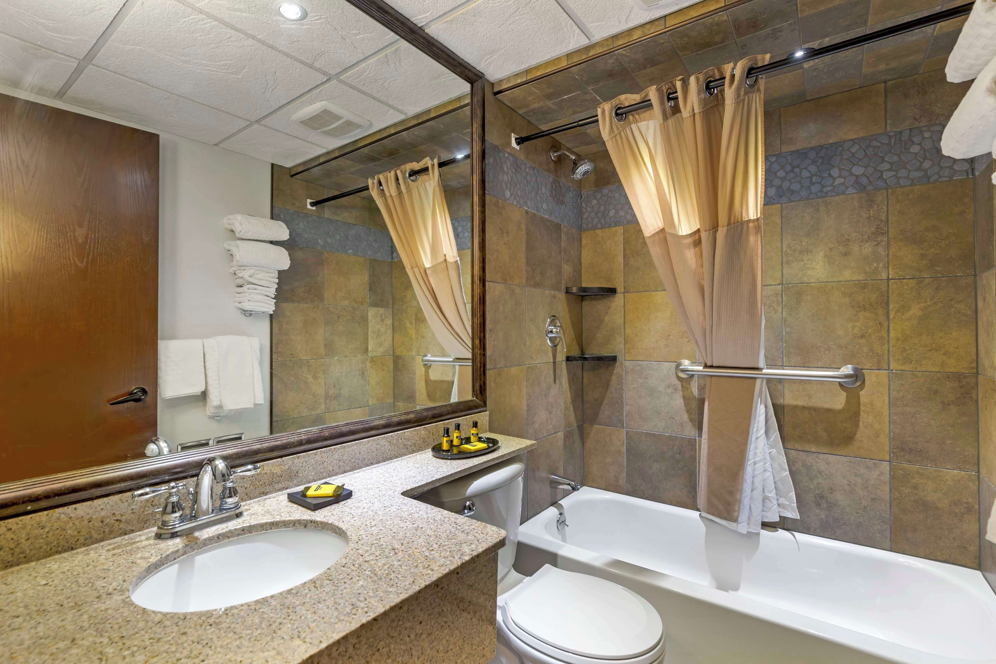 suite, multiple beds, non smoking, kitchenette | bathroom | combined shower/bathtub, rainfall showerhead, designer toiletries