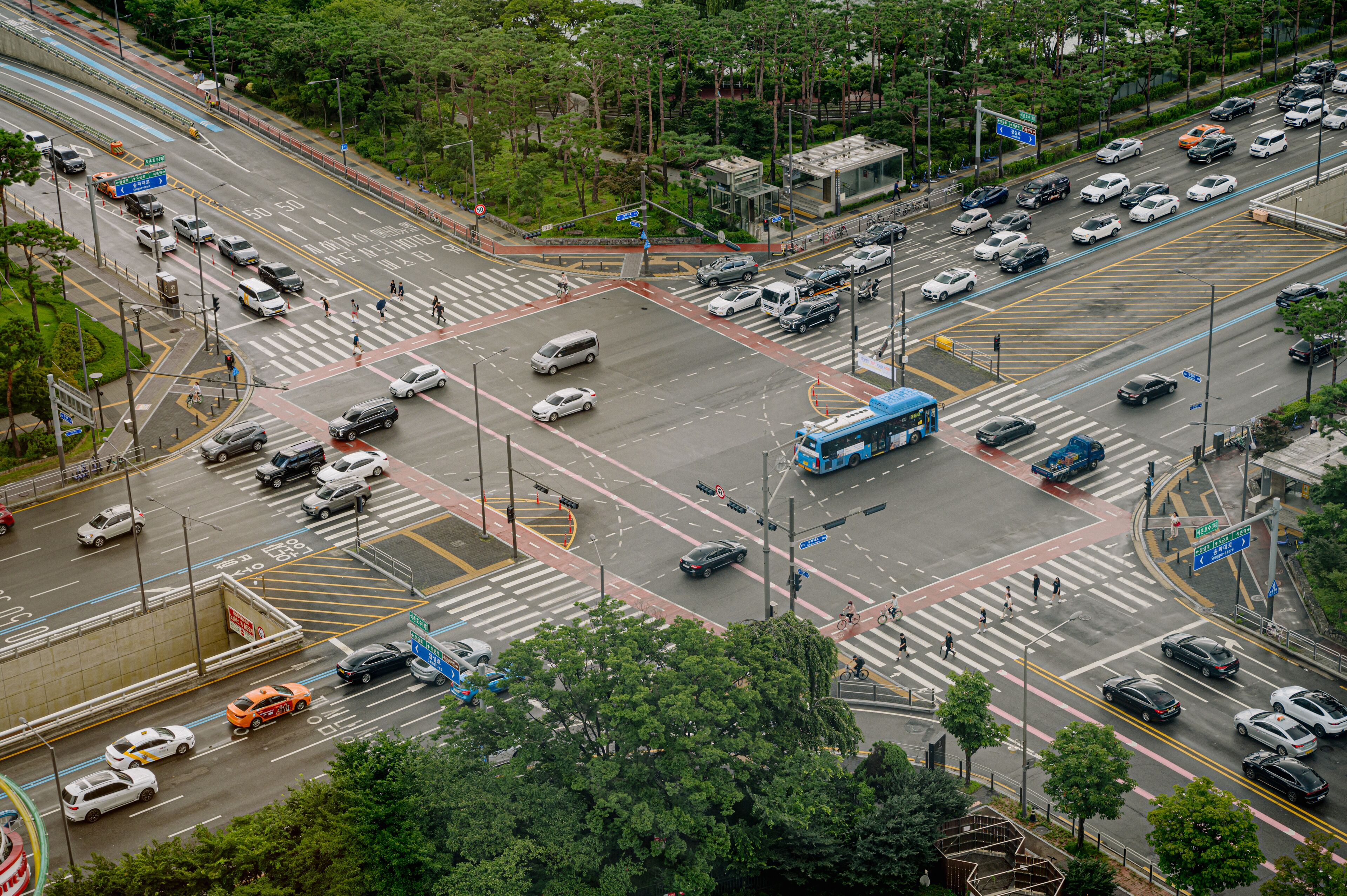 A busy urban intersection with multiple lanes and traffic signals.