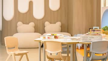 A modern dining area with a table set for four, surrounded by chairs.