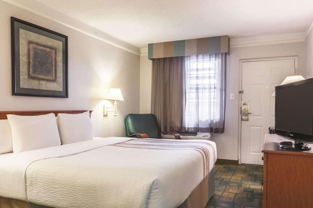 Premium bedding, desk, laptop workspace, iron/ironing board