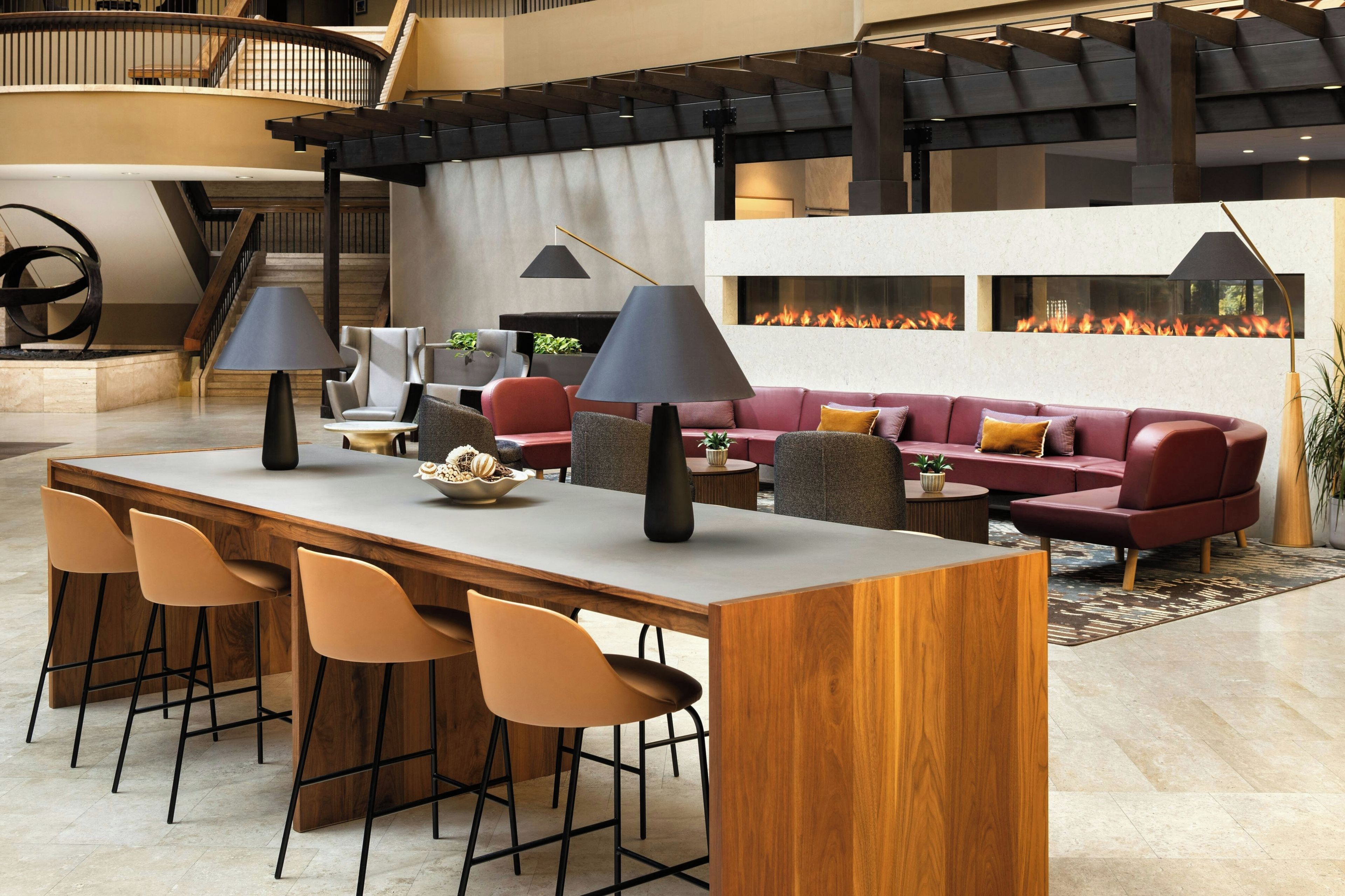 A modern interior with a bar area, seating, and a fireplace.