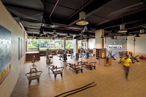 A gym with exercise equipment, large windows, and a view of greenery. - Shangri-La Tanjung Aru, Kota Kinabalu (Kota Kinabalu)