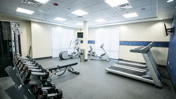A gym with weight machines, treadmills, and exercise bikes.