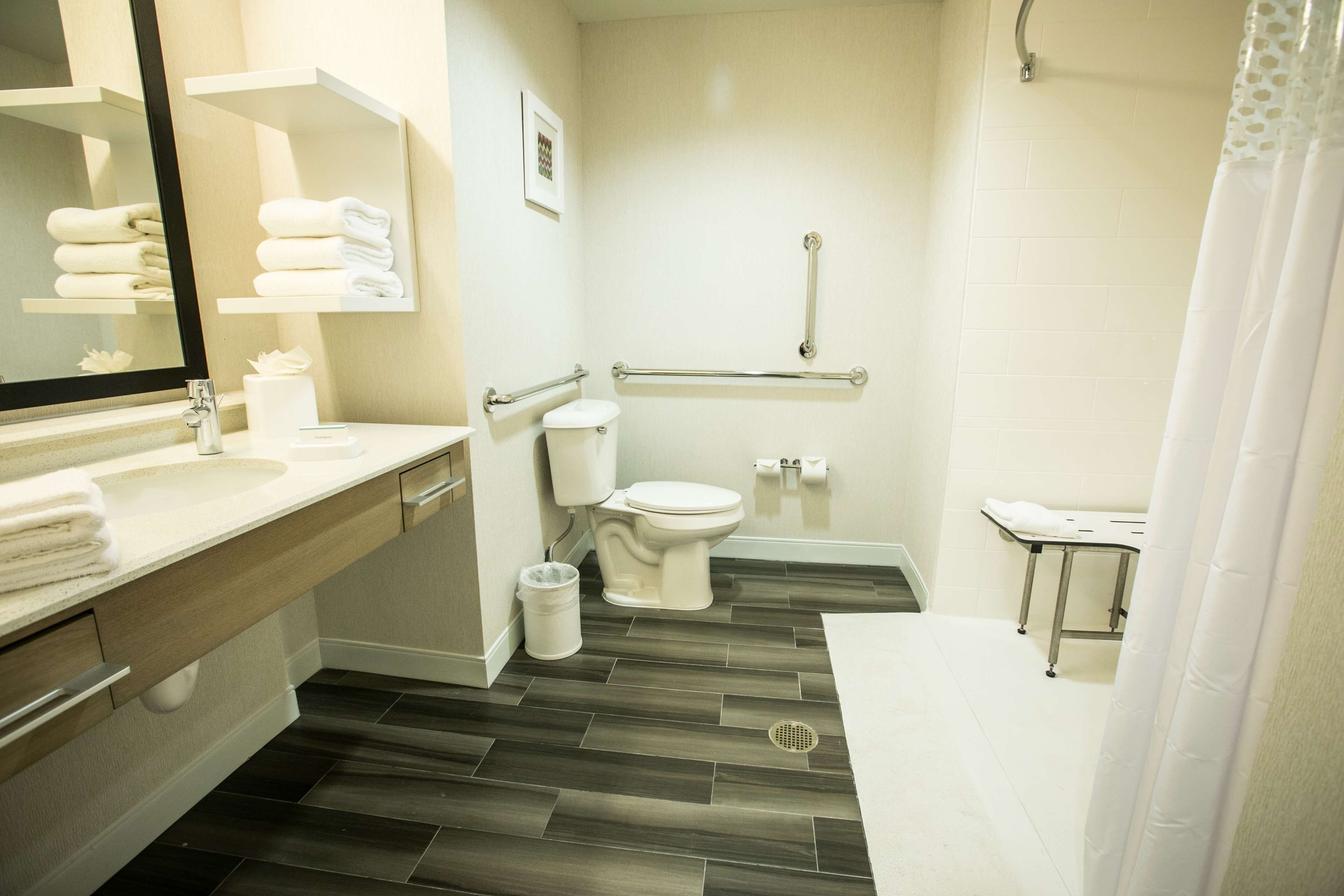 studio, 1 king bed, accessible, non smoking (w/ roll-in shower) | bathroom | combined shower/bathtub, eco-friendly toiletries, hair dryer, towels