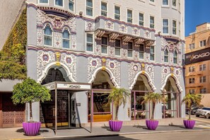A hotel with ornate architectural details, large windows, and a prominent entrance. - Hotel Adagio, Autograph Collection (San Francisco)