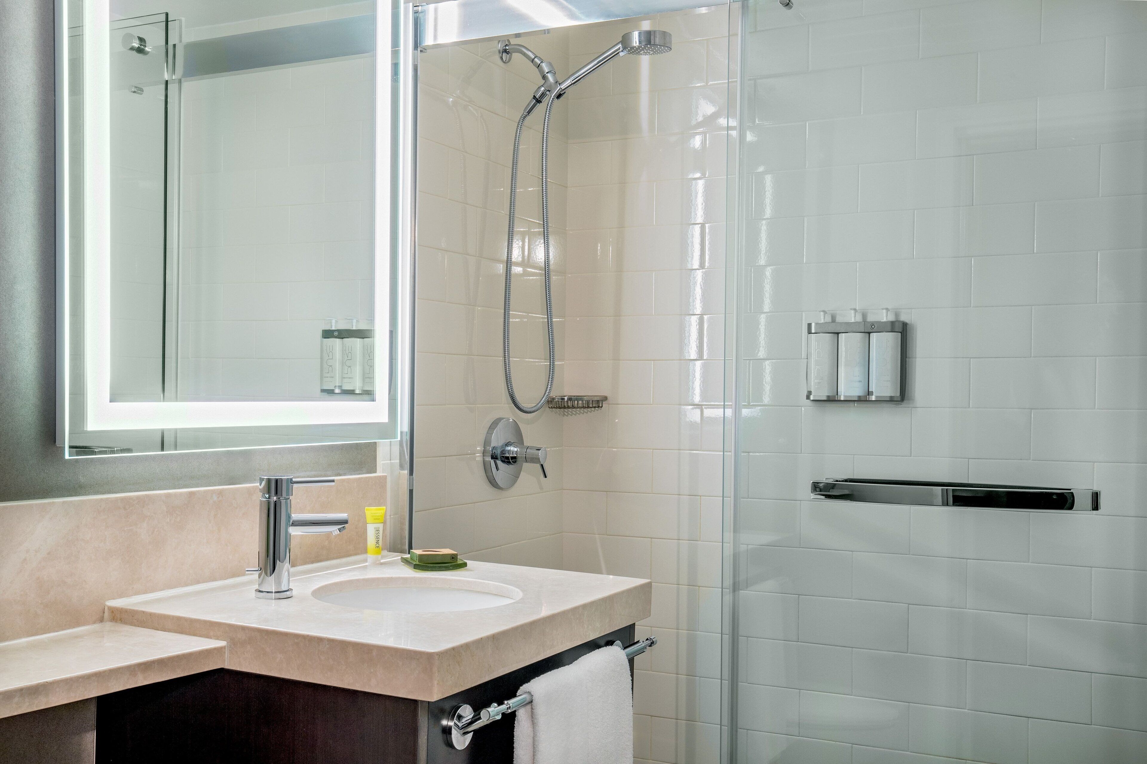 combined shower/bathtub, designer toiletries, hair dryer, bathrobes