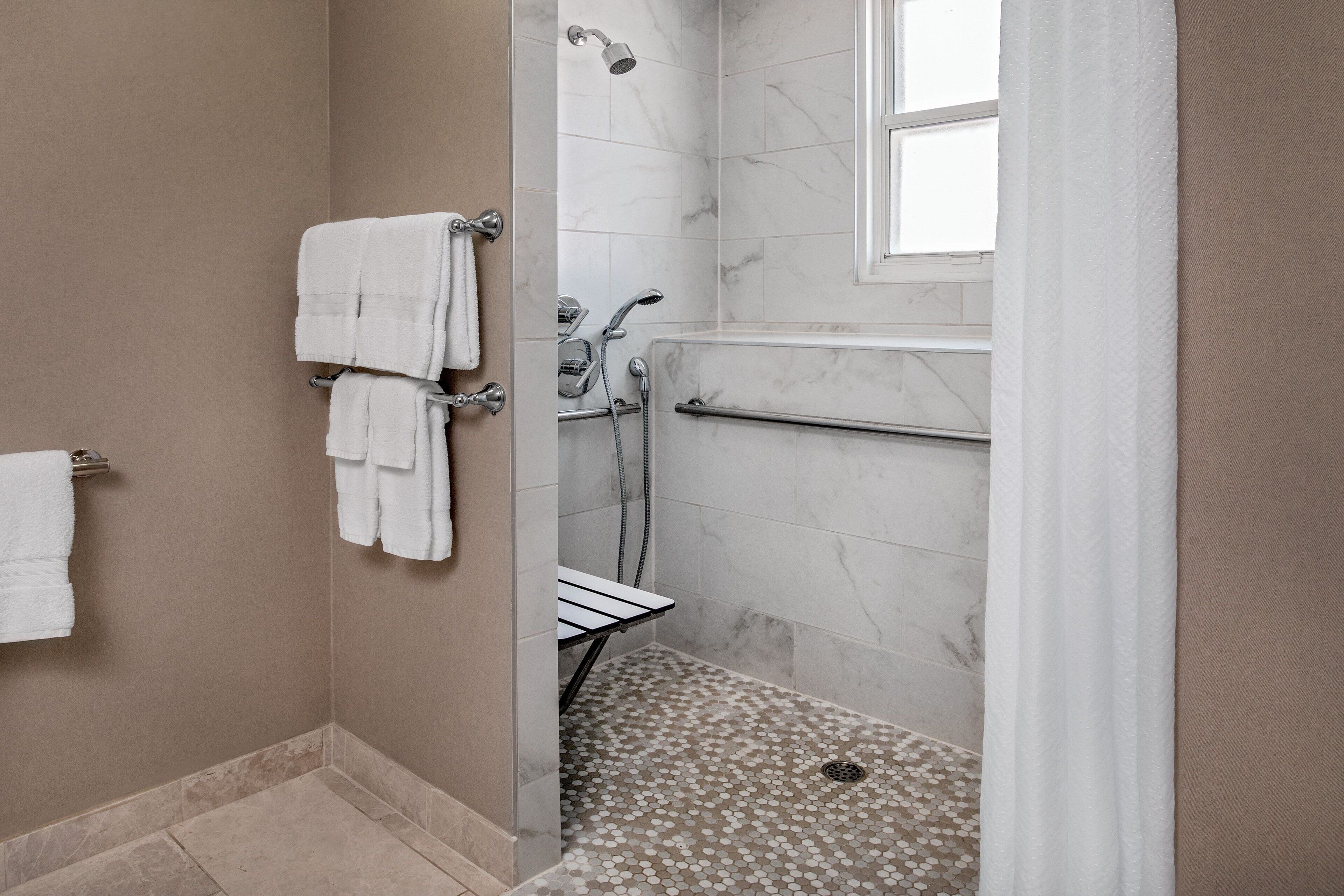 combined shower/bathtub, designer toiletries, hair dryer, bathrobes
